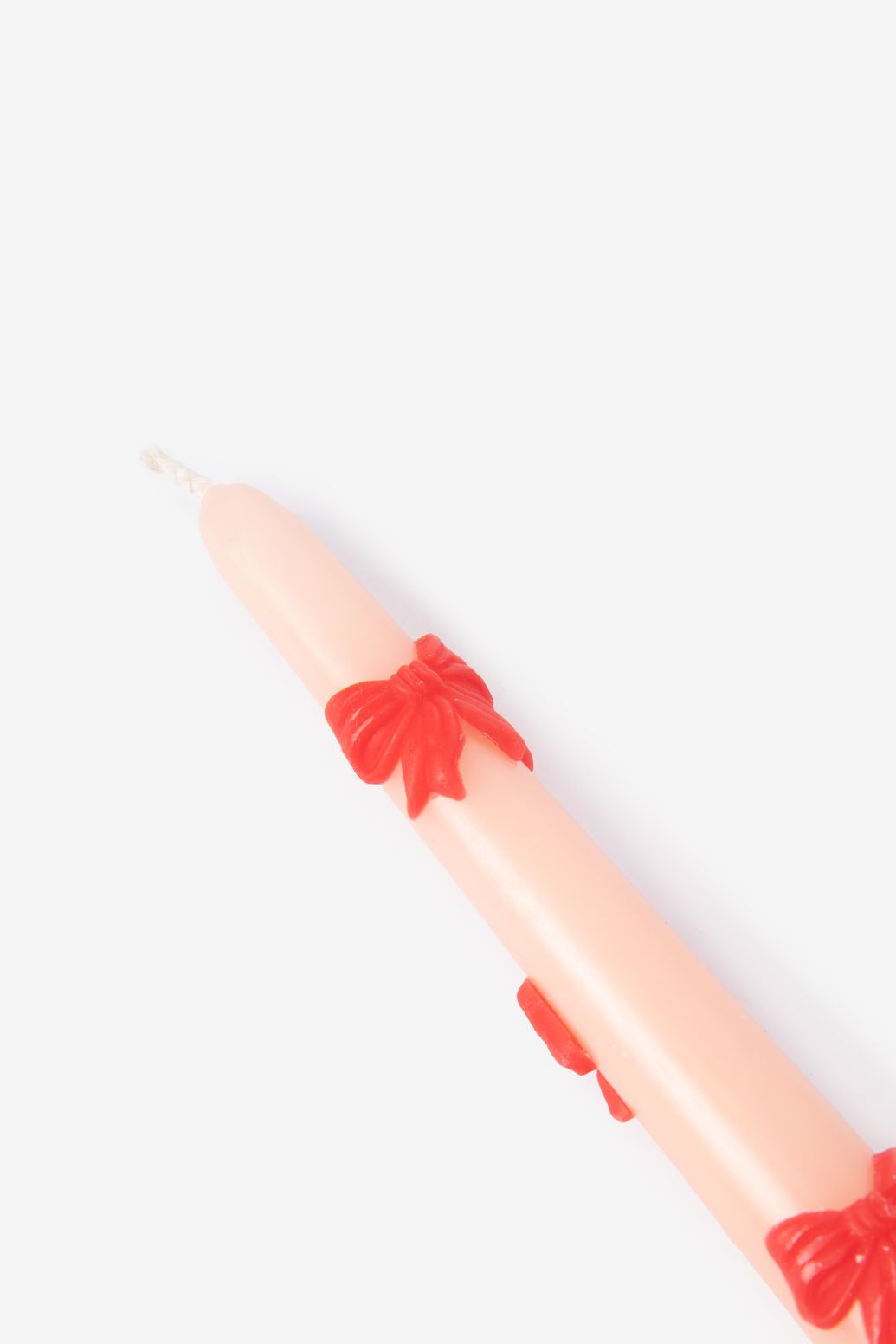 Lichtroze sierkaarsen met strikjes