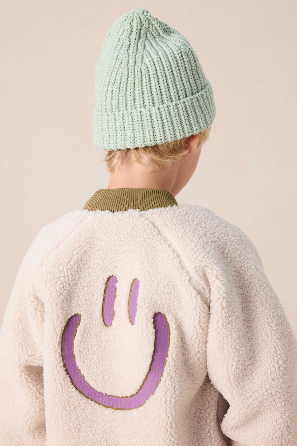 Witte teddy jas met smiley